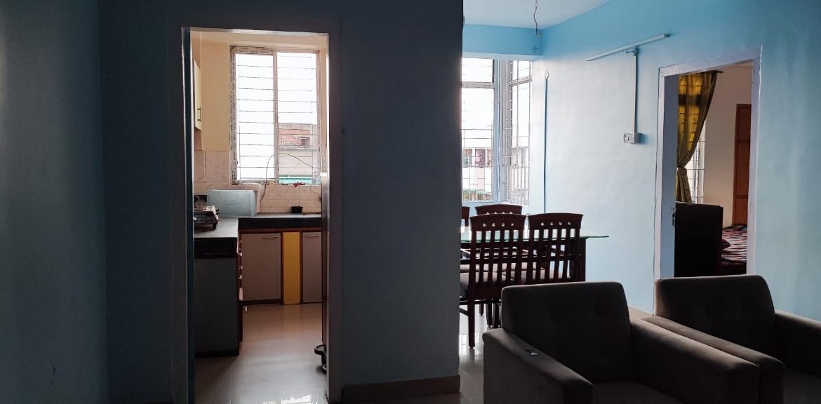 Fully furnished 2 BHK flat for rent at Bhangagarh, Guwahati, 3rd floor, under ₹20,000 with modern amenities including sofa, dining set, and modular kitchen