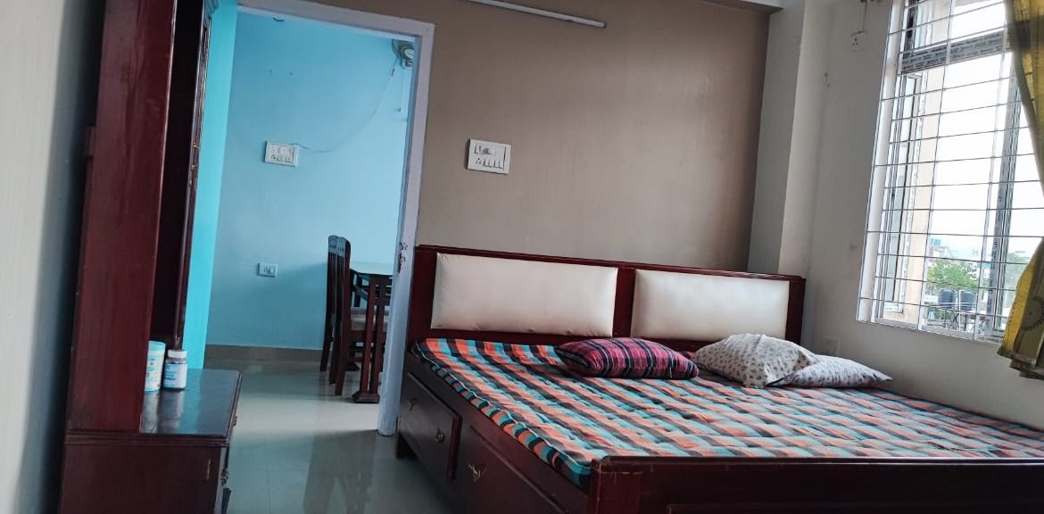 Affordable fully furnished 2 BHK flat at Bhangagarh, Guwahati, prime location, featuring gas stove, cylinder, dressing table, and spacious wardrobes