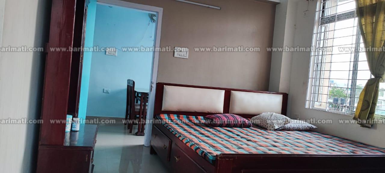 Affordable fully furnished 2 BHK flat at Bhangagarh, Guwahati, prime location, featuring gas stove, cylinder, dressing table, and spacious wardrobes